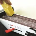 Abrasive belt cleaner